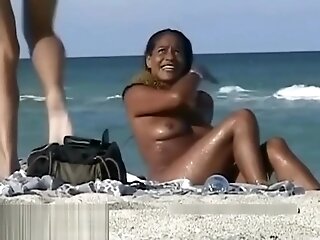 Naked hotties followed around by a nude beach