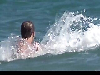 Big boobs woman playing with cock on nude beach